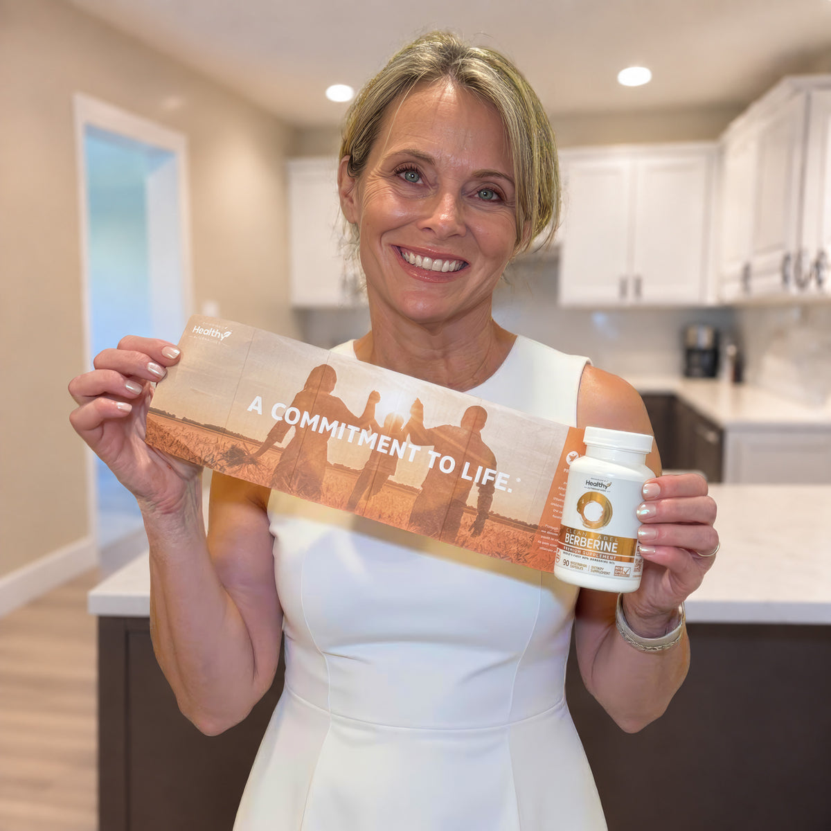 Woman holding a PHA bottle and A Commitment to Life card